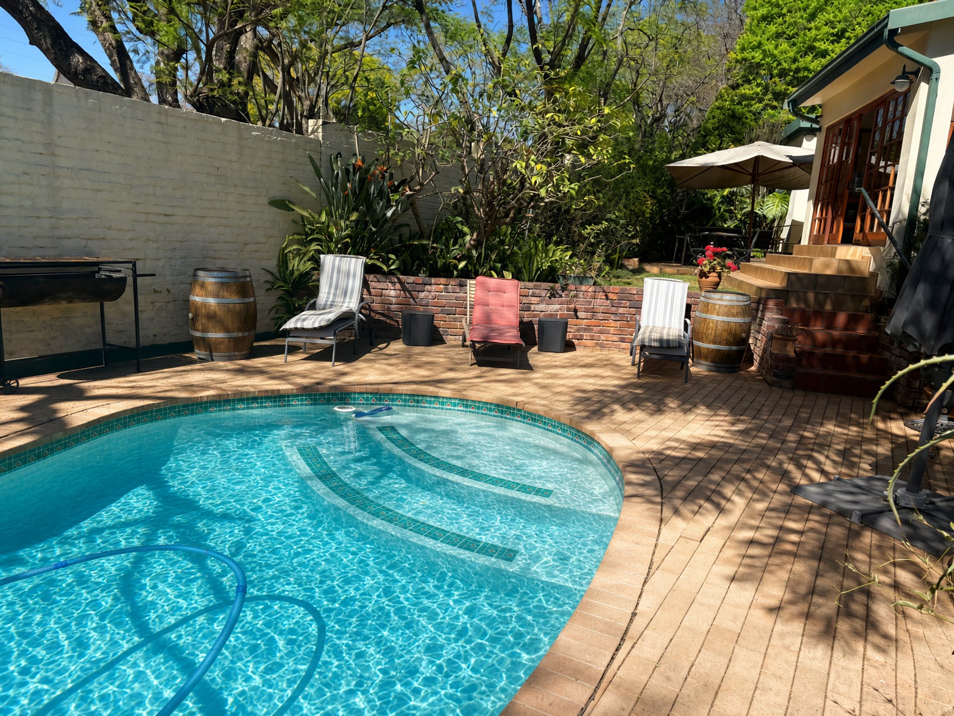 Garden pool and veranda at a Parkview guesthouse